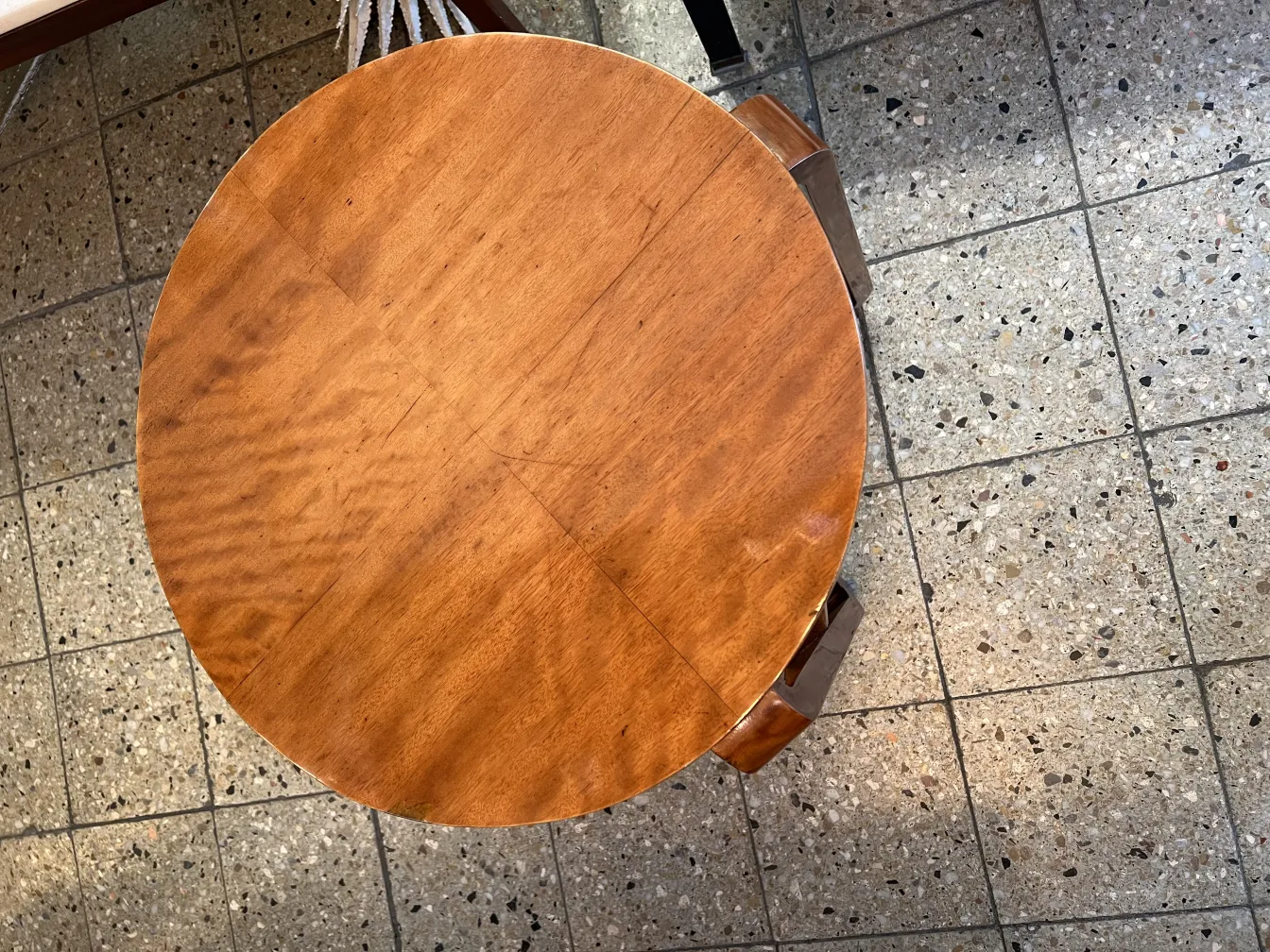 Antique small round table with wooden surface in a neutral setting.