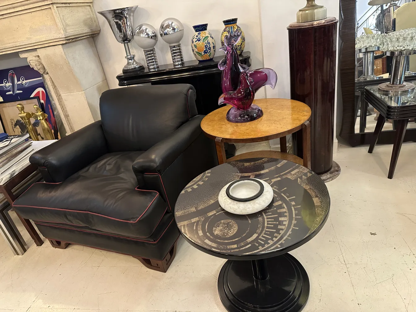Antique decorative small table with an elegant design, surrounded by art and accessories.