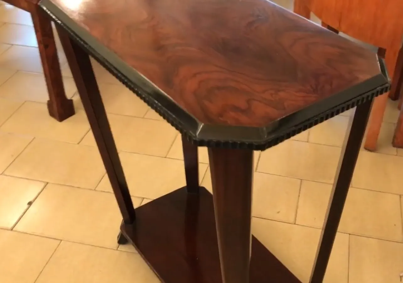 small antique table with a polished surface and elegant legs