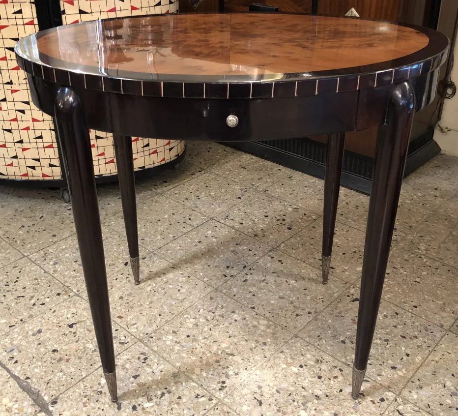 Antique small table with an elegant design and stylish legs.