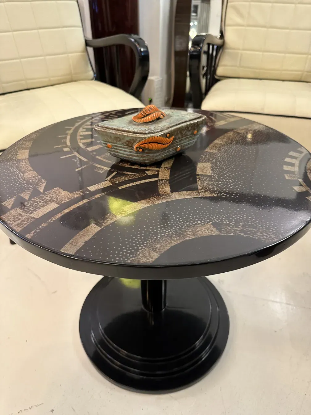 antique small table with decorative design on surface