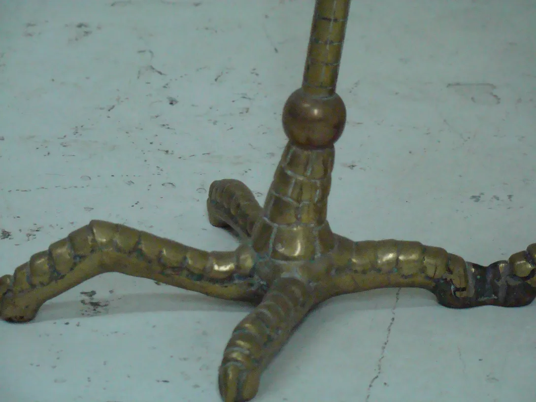 Antique table base with intricate bronze design and curved shapes.