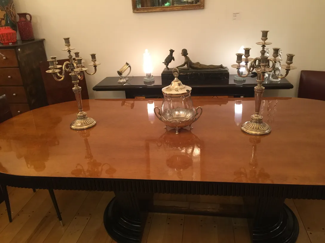 two antique candelabras on a wooden table, creating a warm and elegant atmosphere.