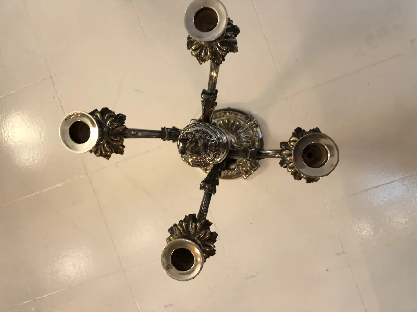 two antique candelabras with decorative details