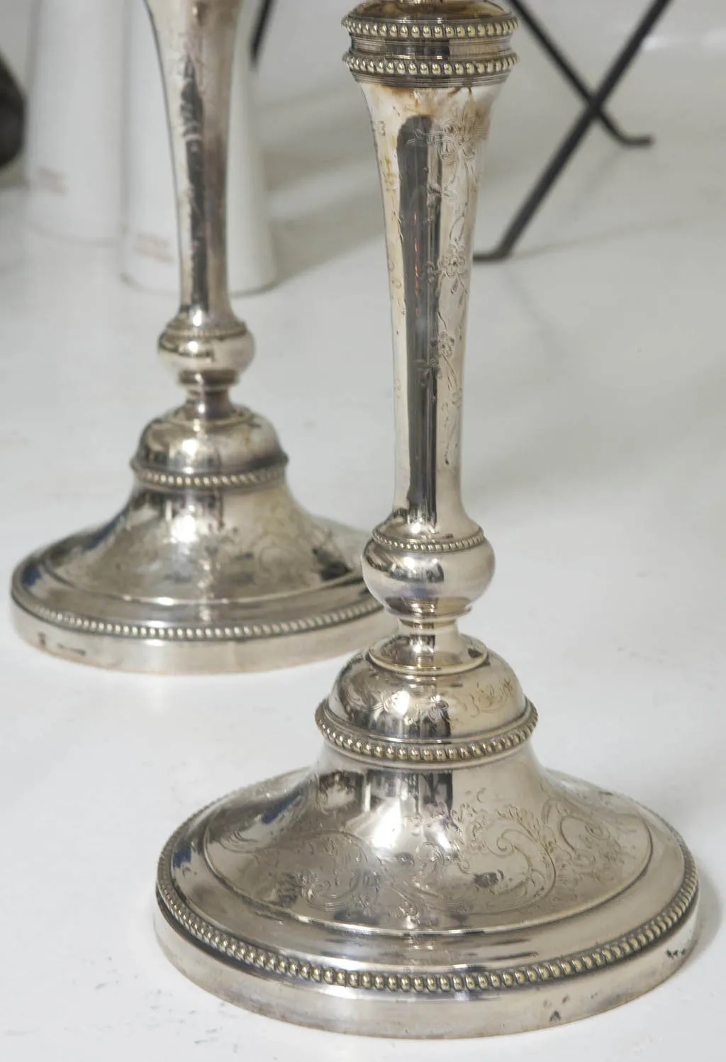two elegant antique candelabras with artistic details