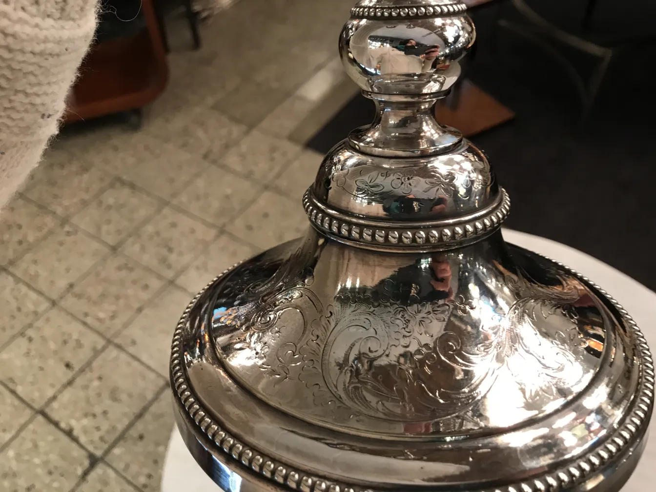 Detailed view of 2 antique candelabras with engravings in a cozy environment