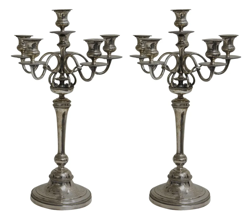 two antique candelabras with decorative base and multiple arms