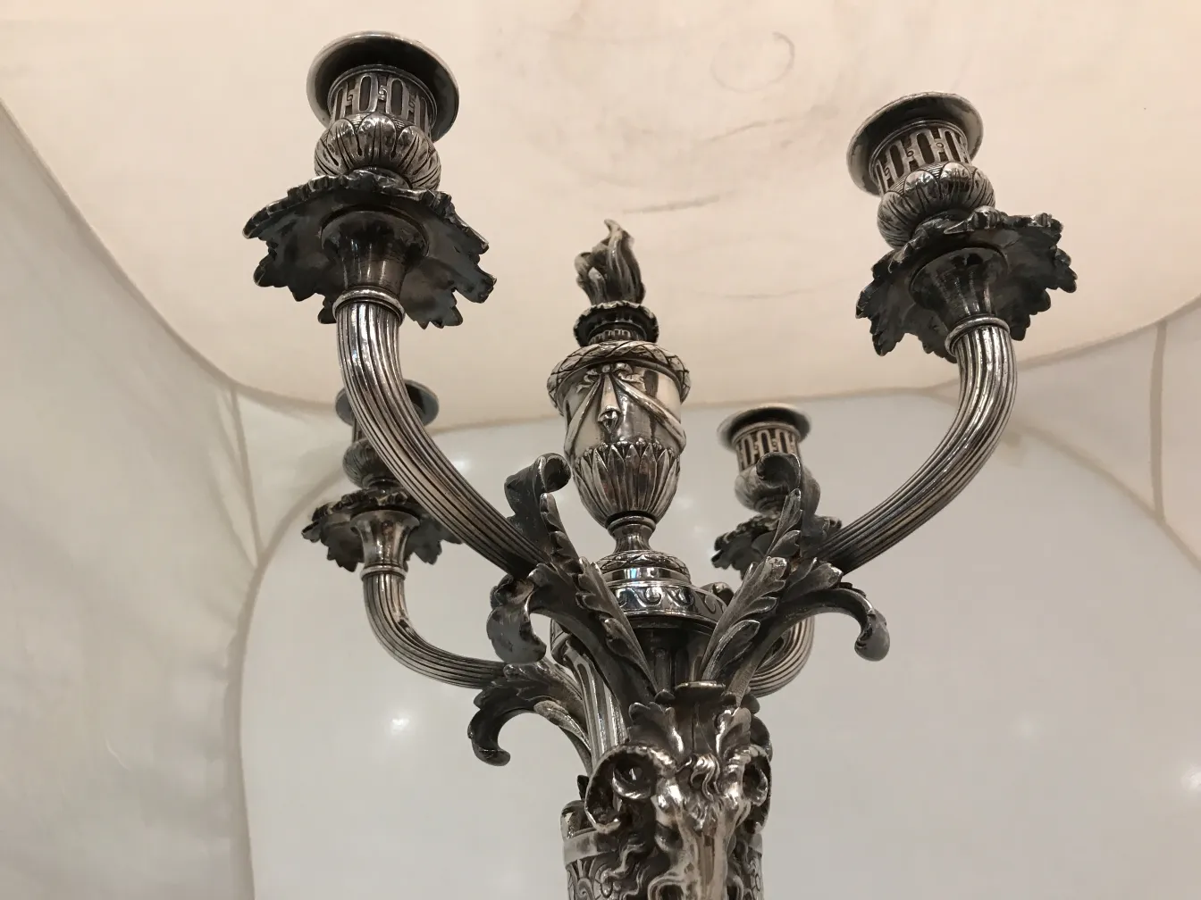 Antique candelabras with intricate details in a decorative setting
