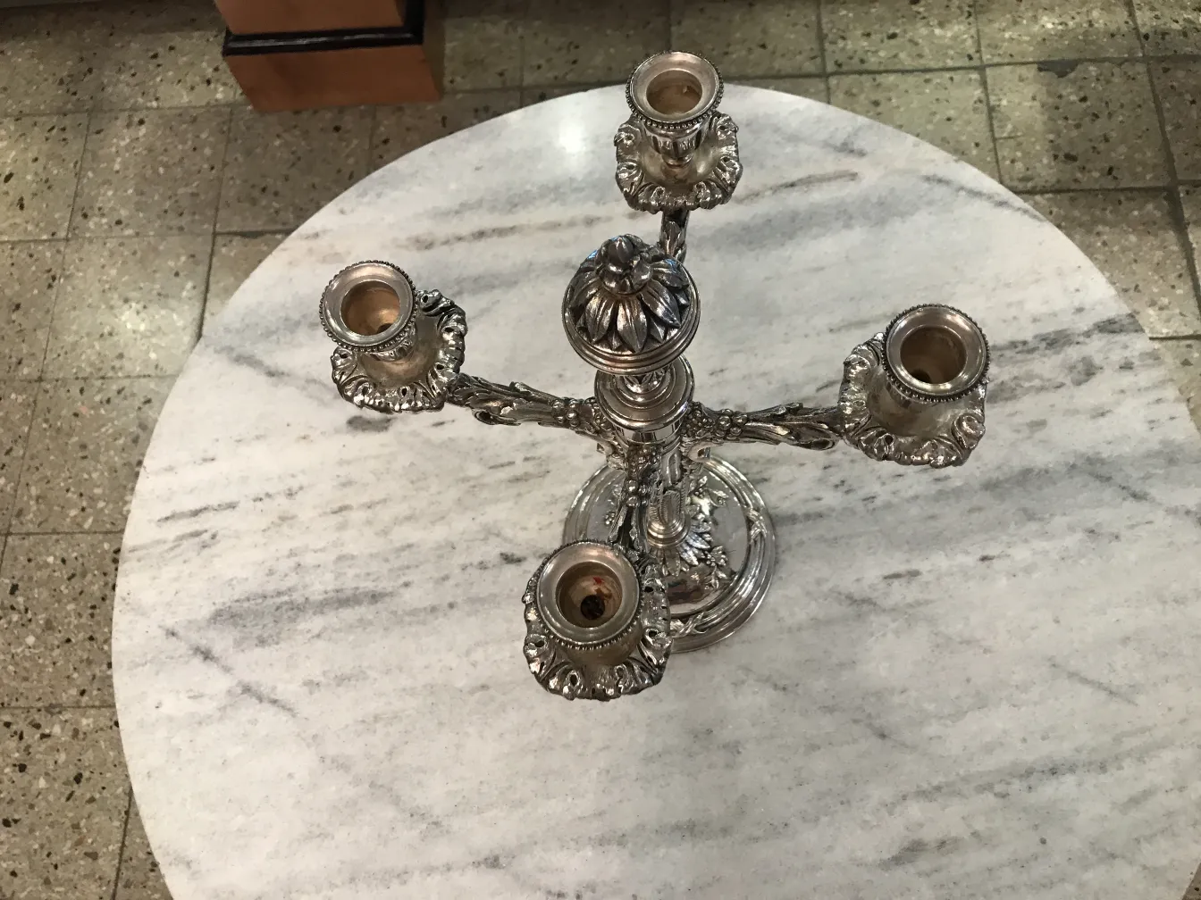 2 antique candelabras art nouveau on marble table with neutral background.