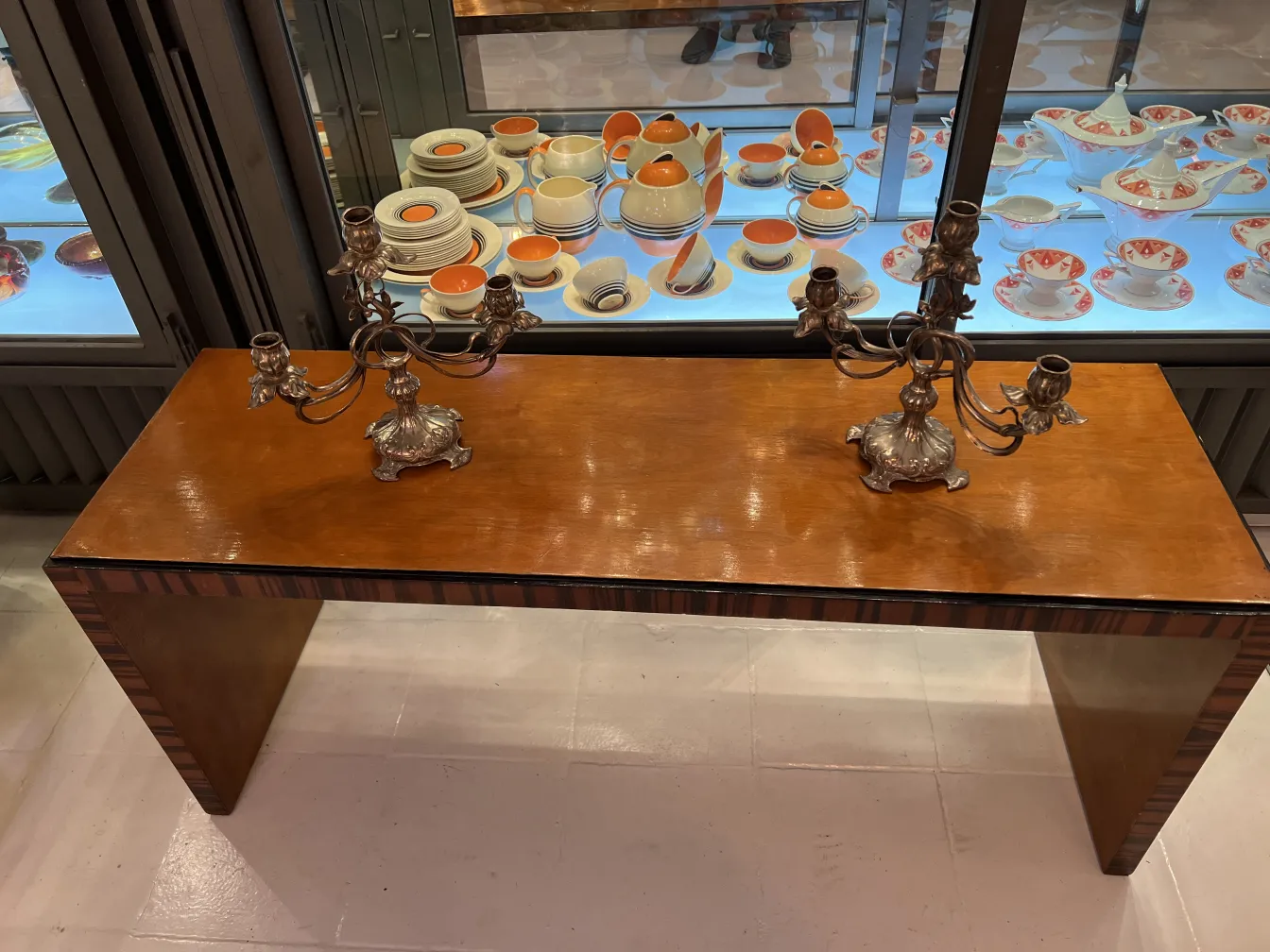 two antique candelabras on a wooden table, decorative art