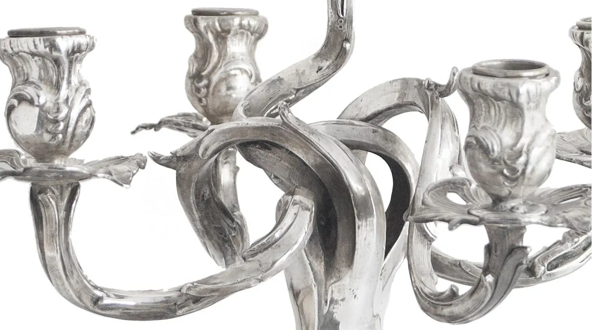 two antique candelabras with artistic details