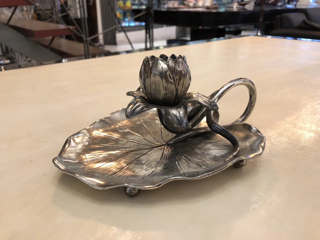 Antique candelabra featuring a flower design on a leaf base