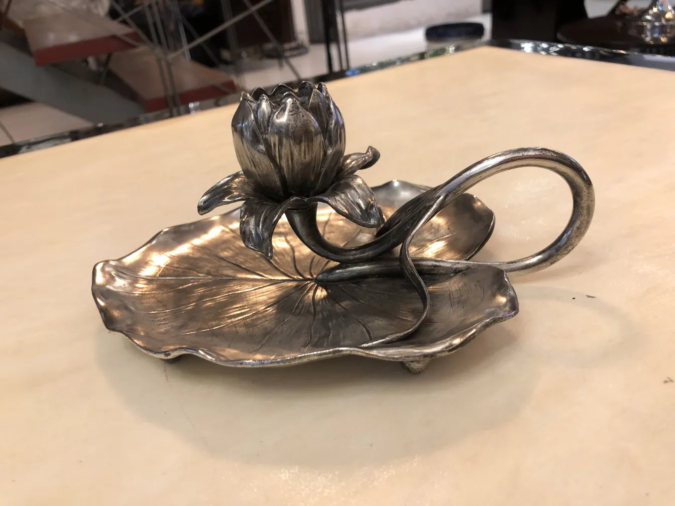 Antique candelabra with flower design at the base, elegant and artistic.