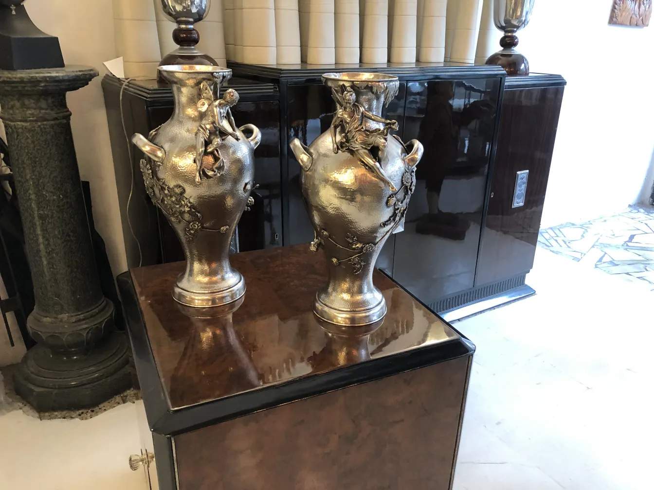 2 antique art nouveau vases with decorative details in an elegant setting