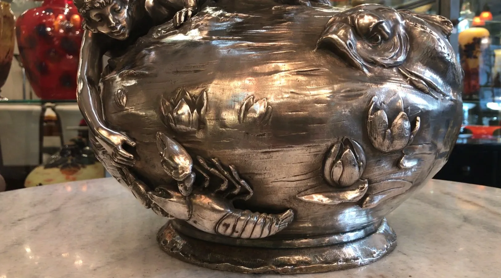 two antique vases featuring aquatic design and floral details