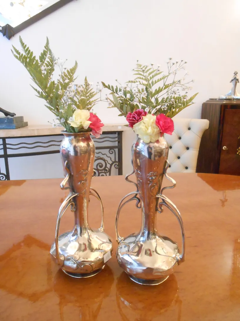 antique vases with flowers on a stylish table