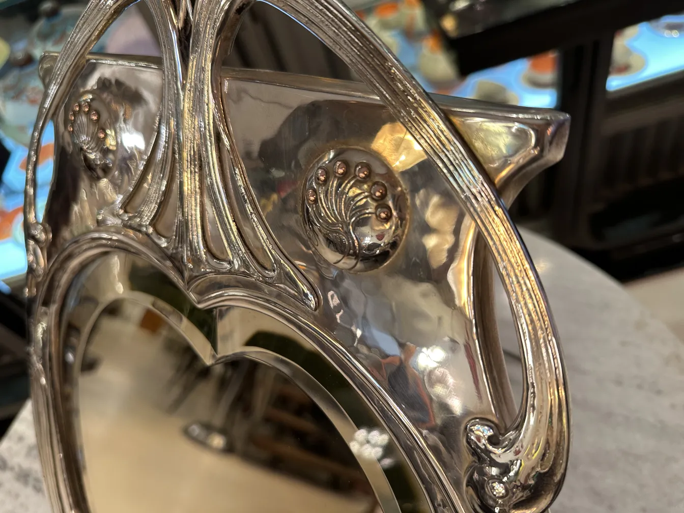 Antique mirror featuring Art Nouveau design with decoration.