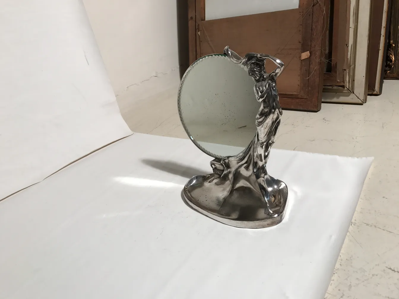 antique mirror with ornamental figure base