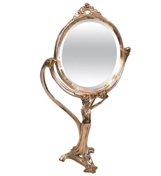 antique oval mirror with a female figure holding the frame