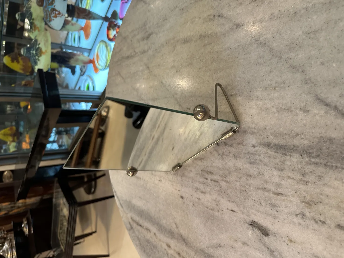 antique mirror with stand, reflecting details of the environment