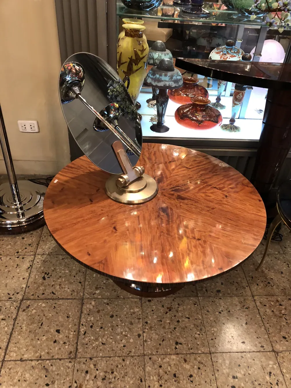 large antique mirror with round base in a vintage setting