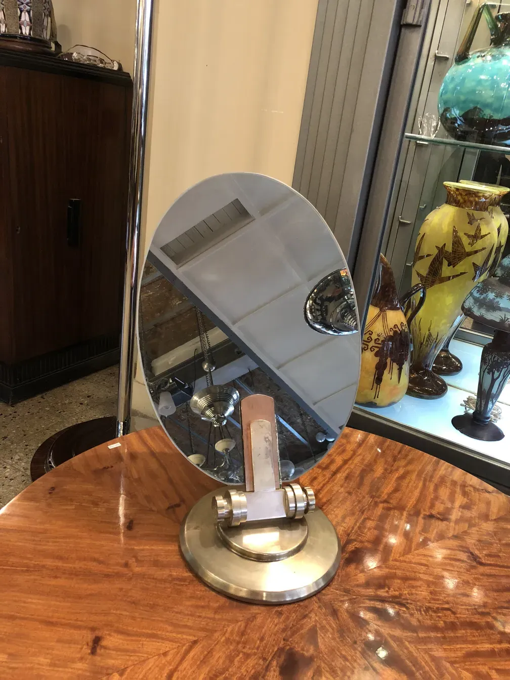 antique oval mirror with metal stand in classic setting