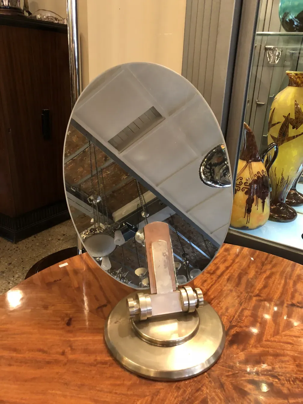 antique oval mirror with circular base