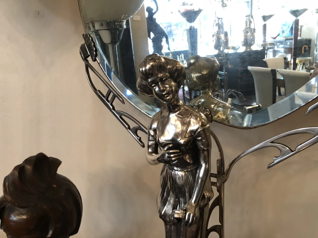 antique mirror with silver figure and art nouveau details, decorative background