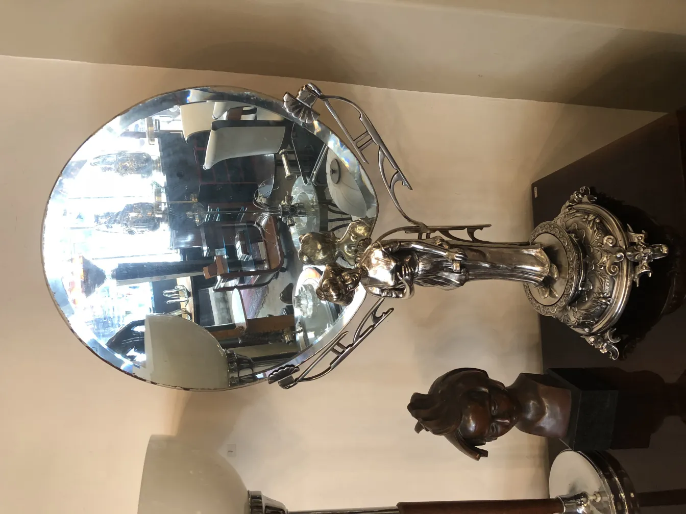 Antique mirror with decorative base in Art Nouveau style.