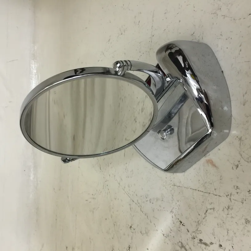 antique mirror with shiny round base on a light background