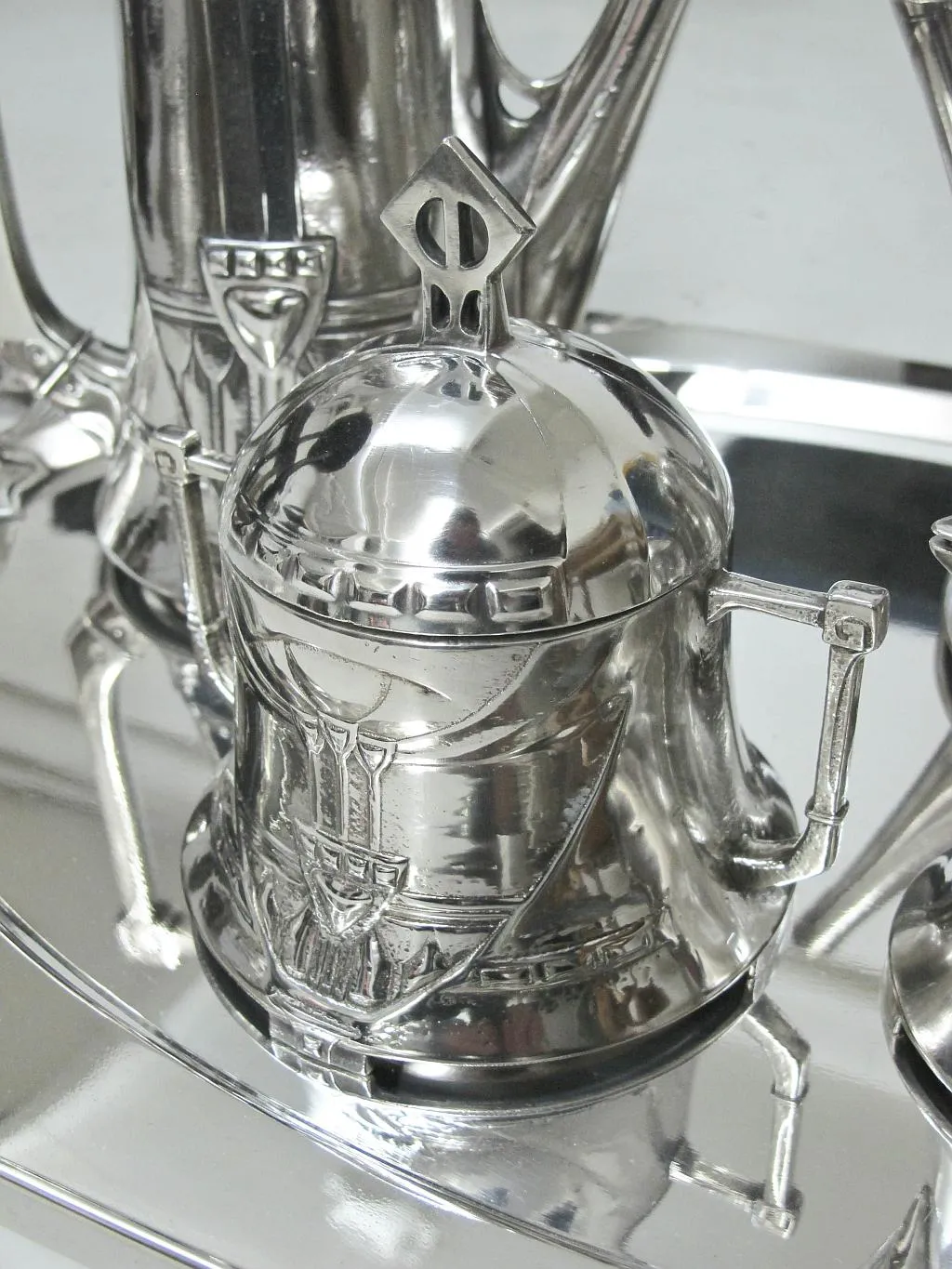 Antique WMF tea set with clear decorative details, showcased in an elegant setting.