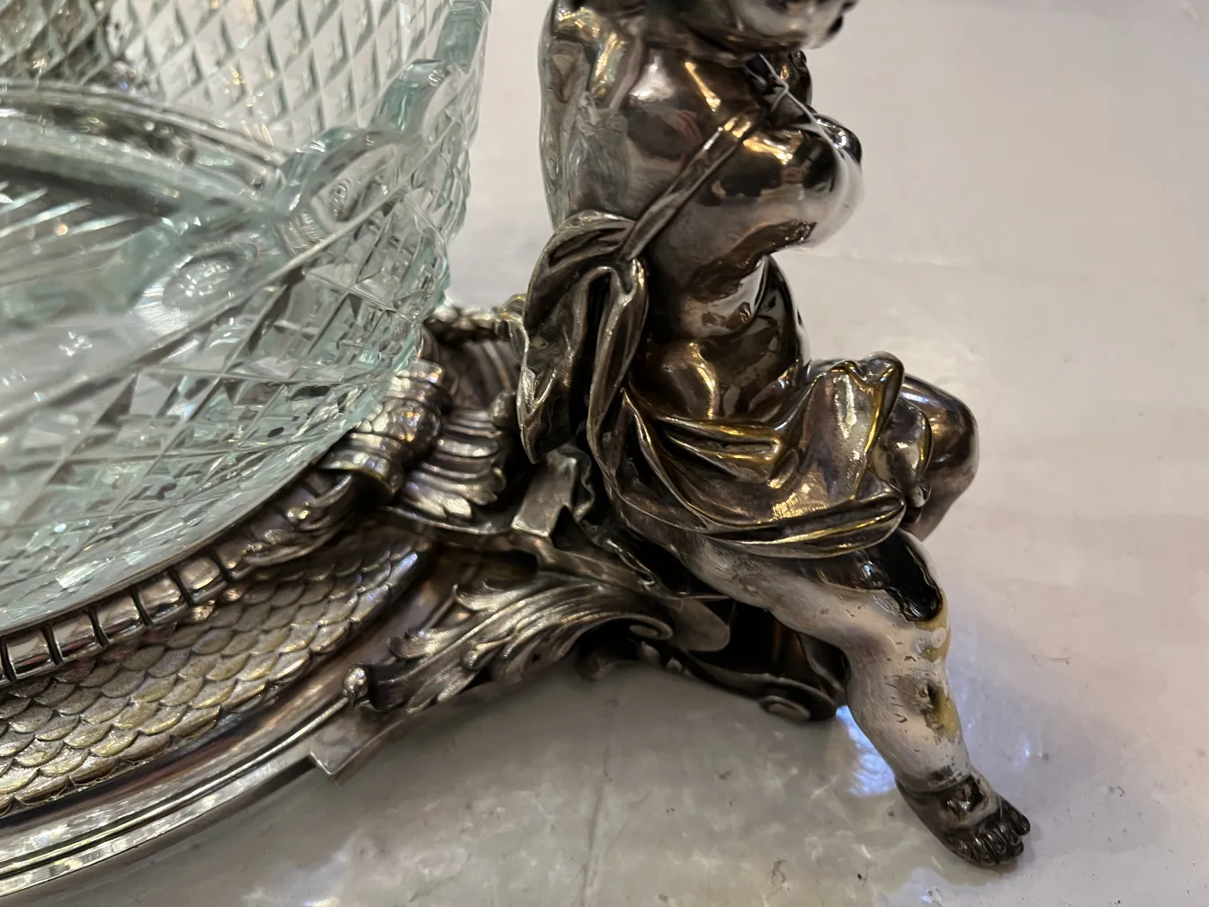 Antique Christofle centerpiece with decorative details and sculpted figure.