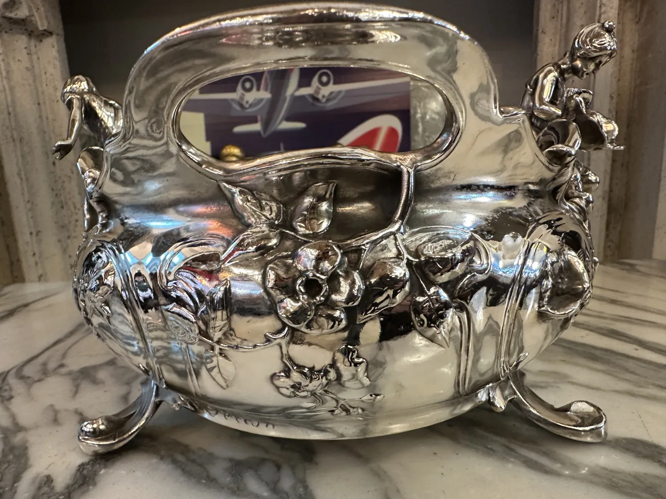 antique centerpiece with floral and figure decorations