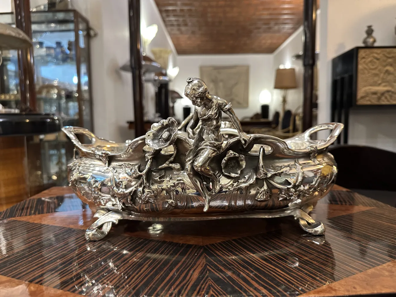 Antique centerpiece with a human figure and ornamental details.