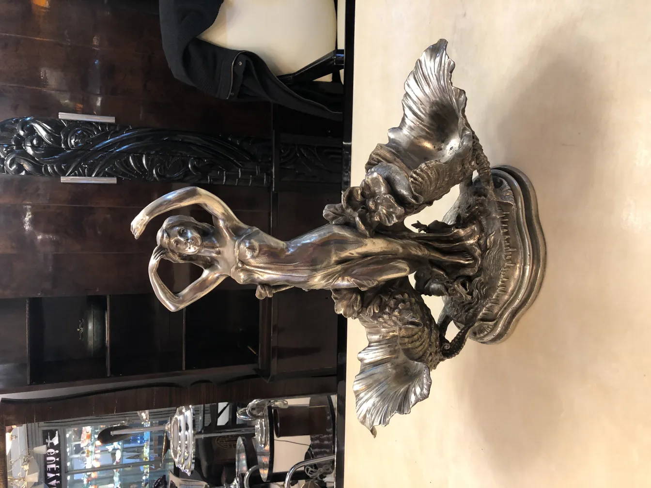 antique centerpiece featuring a female figure and shells