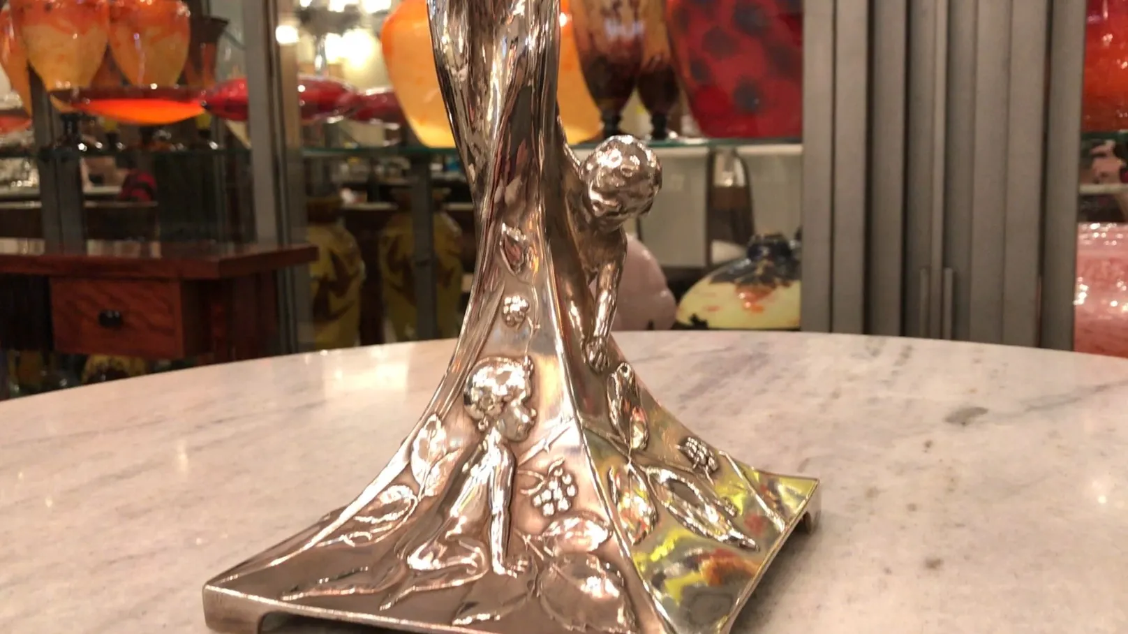 antique WMF centerpiece with relief details featuring angelic figures, in an elegant setting