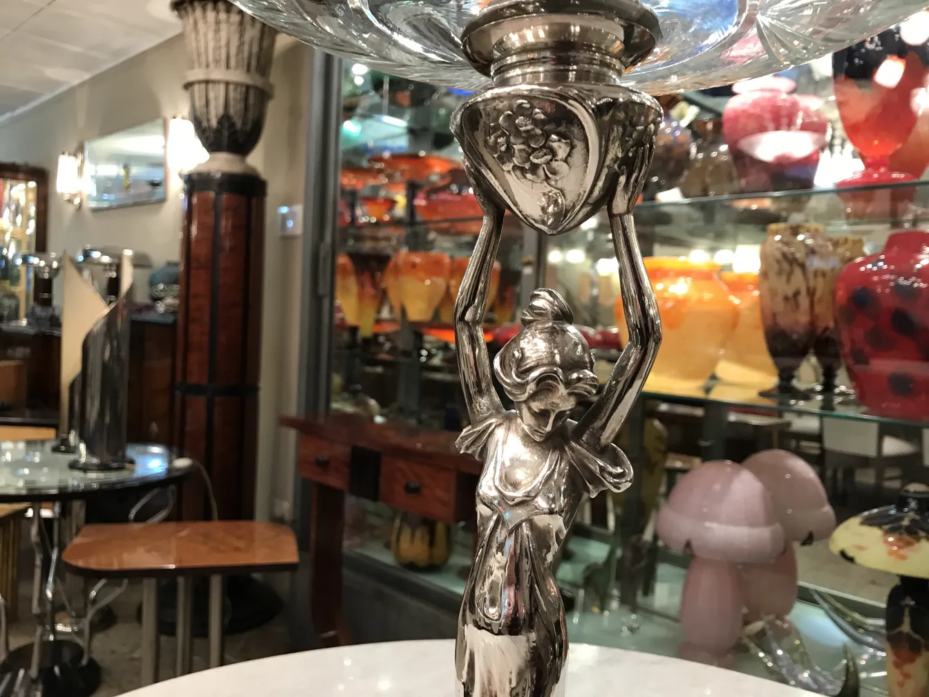 antique WMF centerpiece with decorative figure and colorful background