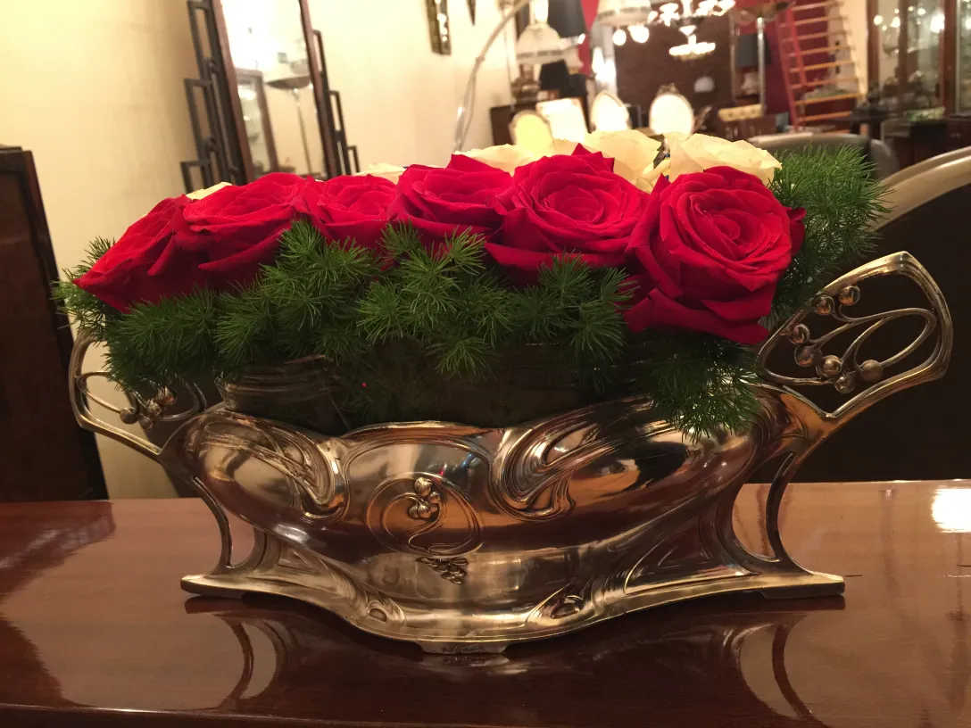 Antique WMF centerpiece with red flowers and greenery