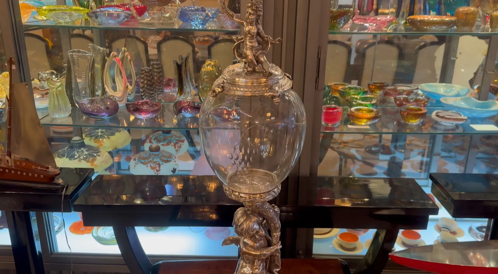 antique centerpiece wmff with floral decorations, colorful glass background