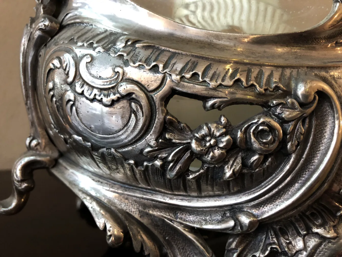 antique wmfs centerpiece with floral decorations in an elegant setting