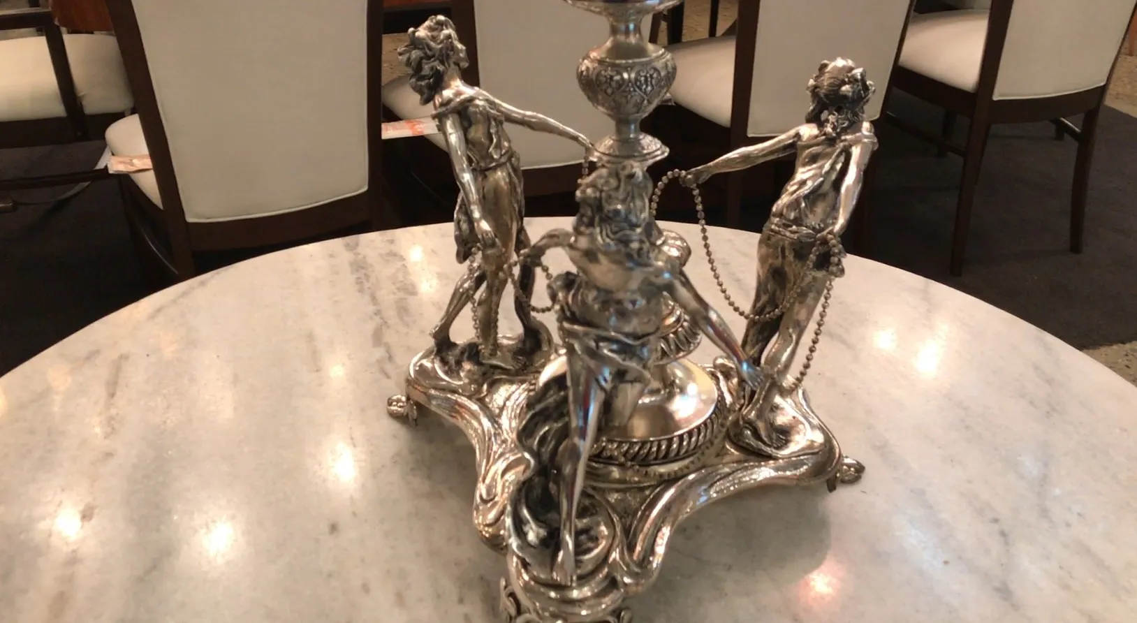 antique centerpiece wmfs with decorative figures on a marble table