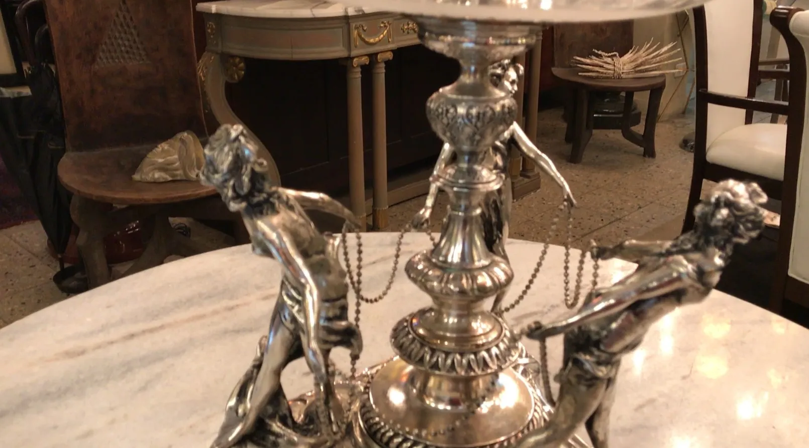 antique WMF centerpiece with decorative figures in a lavish setting