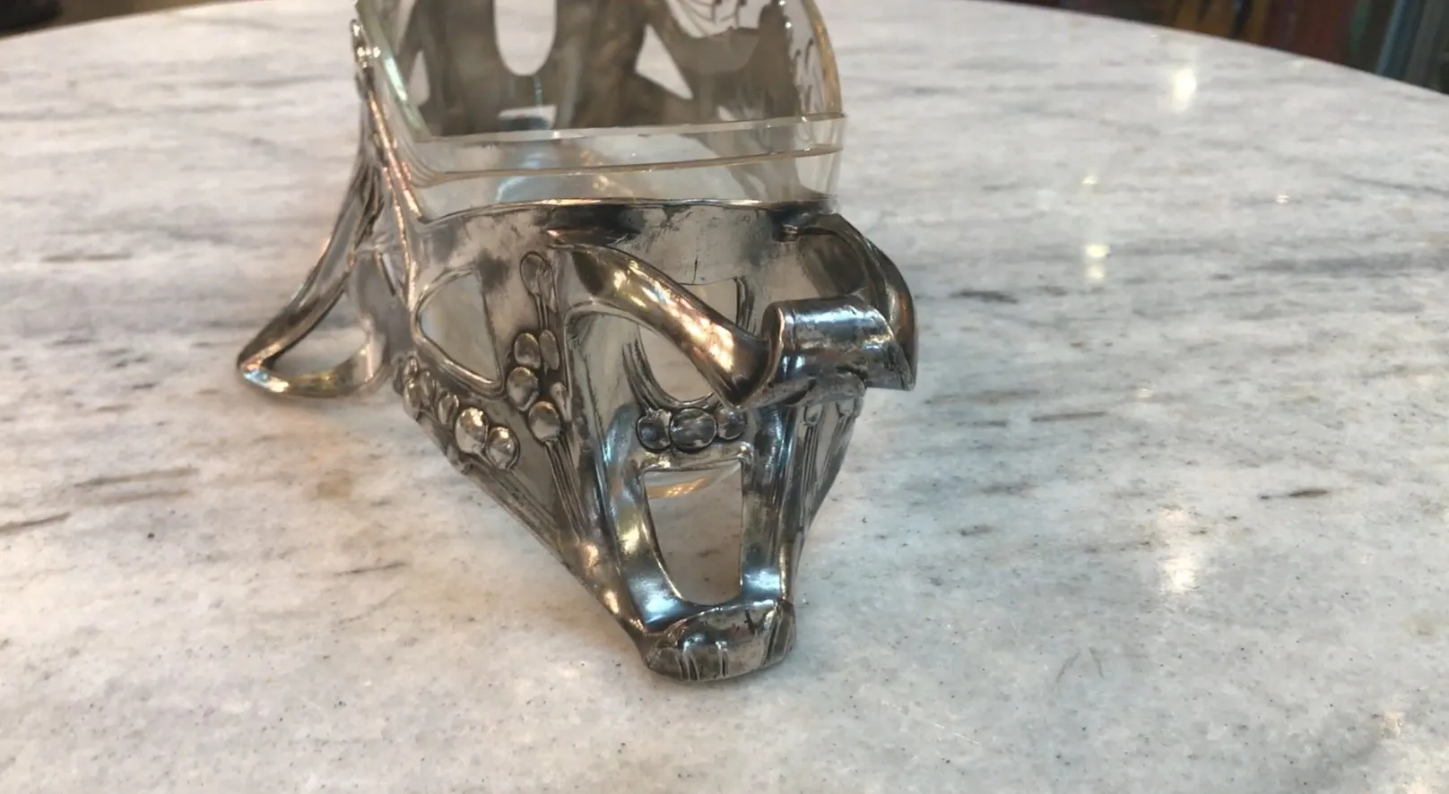 Antique WMF centerpiece on a light marble background.
