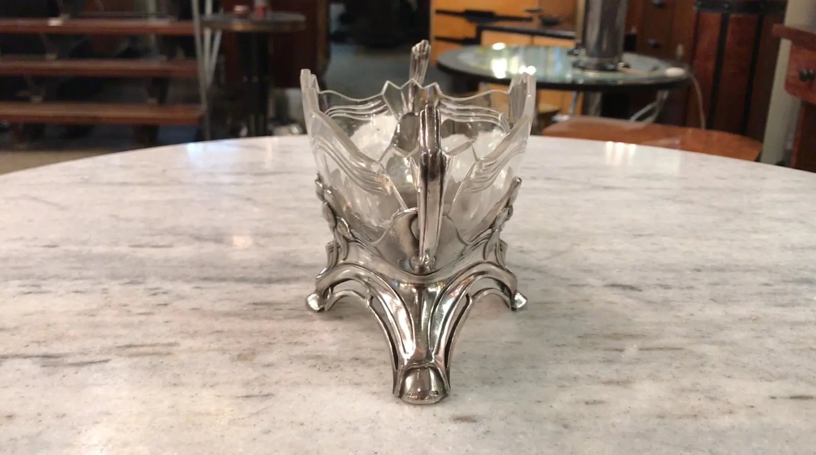 antique WMF centerpiece in decorative shape on marble table