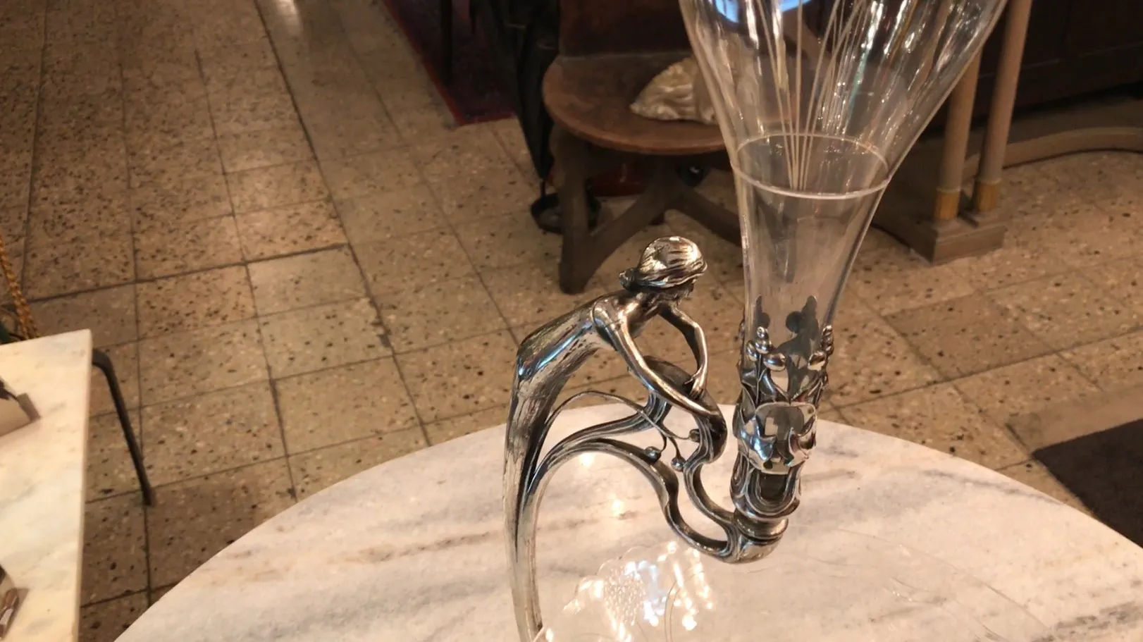 antique wmfs centerpiece in a warm setting with background furniture