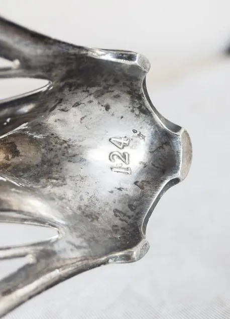 Antique WMF centerpiece featuring decorative edge details, set against a neutral background.