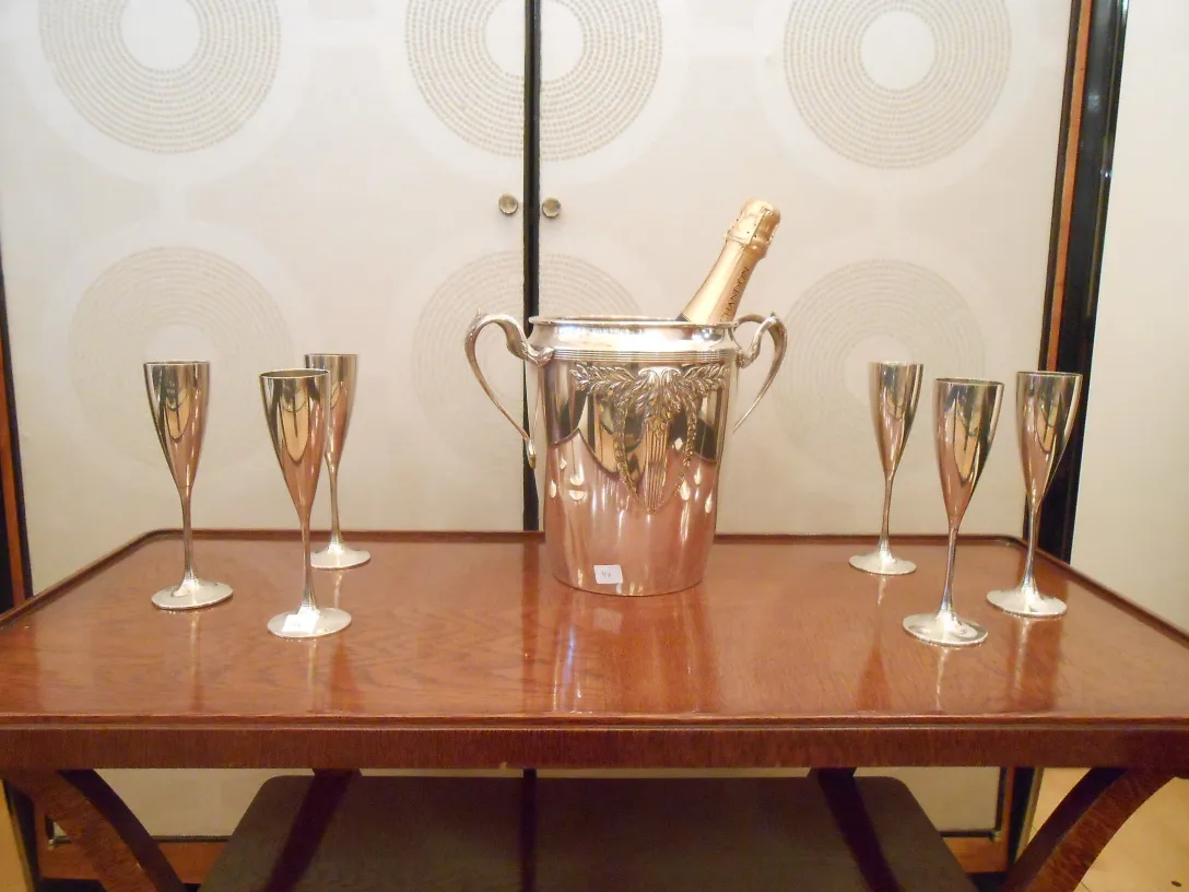 wmf champagne cooler with champagne and glasses on wooden table