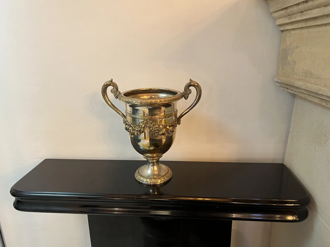 2 antique champagne coolers with decorative handles in a classy setting