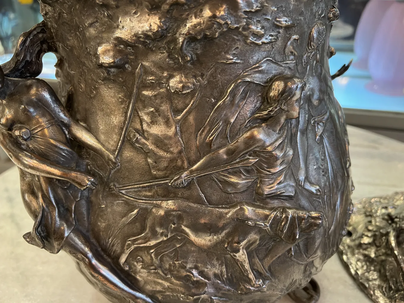 WMF punch bowl featuring reliefs of figures and animals on the surface.