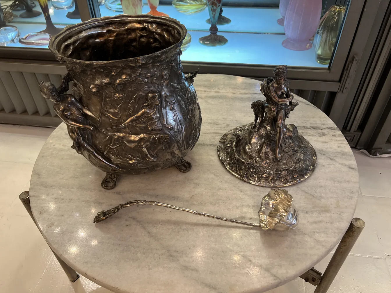 Antique WMF punch bowl with relief and artistic design, elegant setting.